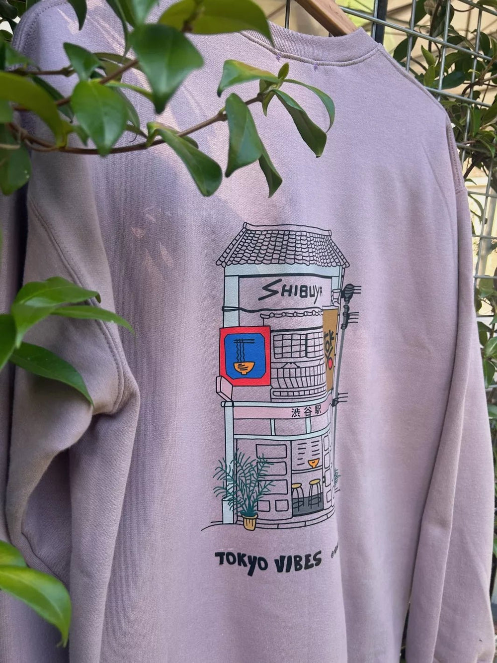 Lavender unisex fleece sweatshirt with hand-drawn Shibuya graphic on back