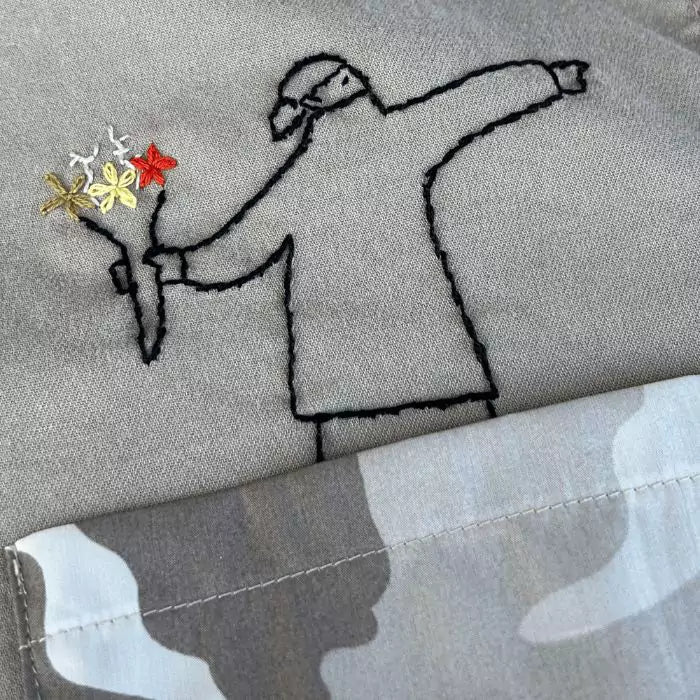 Organic cotton shirt with banksy embroidered above a military pocket