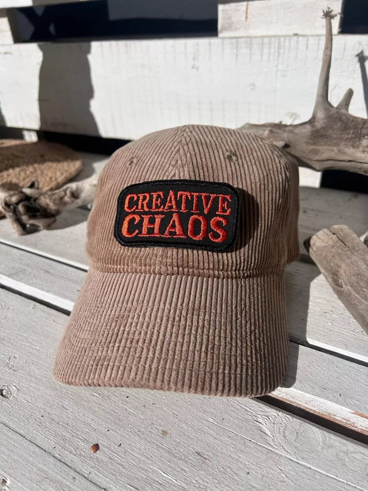 Creative Chaos embroidered iron-on patch with coral-red lettering on a black background