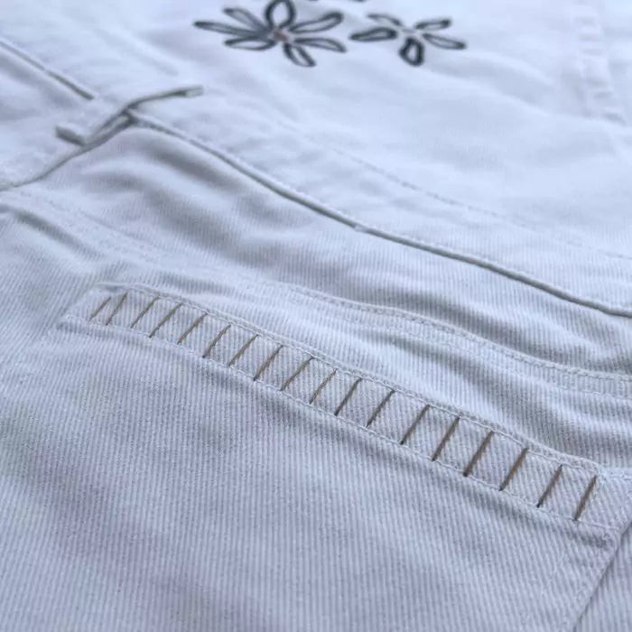 white skirt dungarees in organic cotton with embroidery and stitched fringes