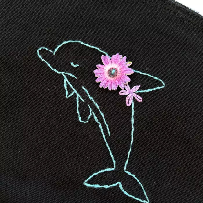 Black organic cotton clutch bag embroidered with a dolphin and flowers on the back
