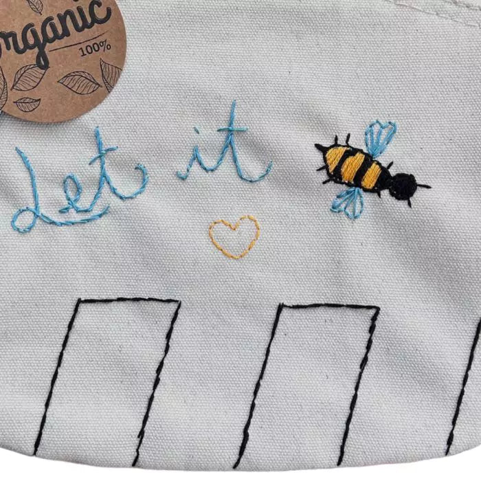 White clutch bag in organic cotton with let it bee by The Beatles embroidered on it