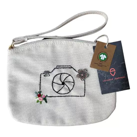 organic cotton clutch bag with a camera and flowers embroidered on it