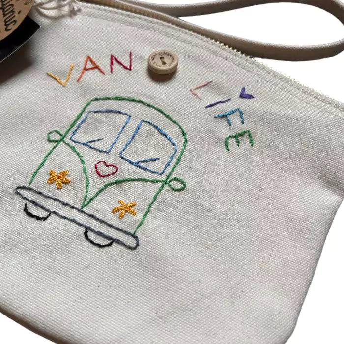 white clutch bag in organic cotton with a camper and the words "van life" embroidered on it