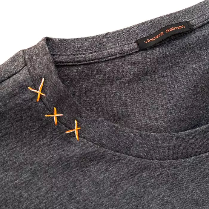 organic cotton t-shirt with yellow striped stitched pocket and matte buttons in the center