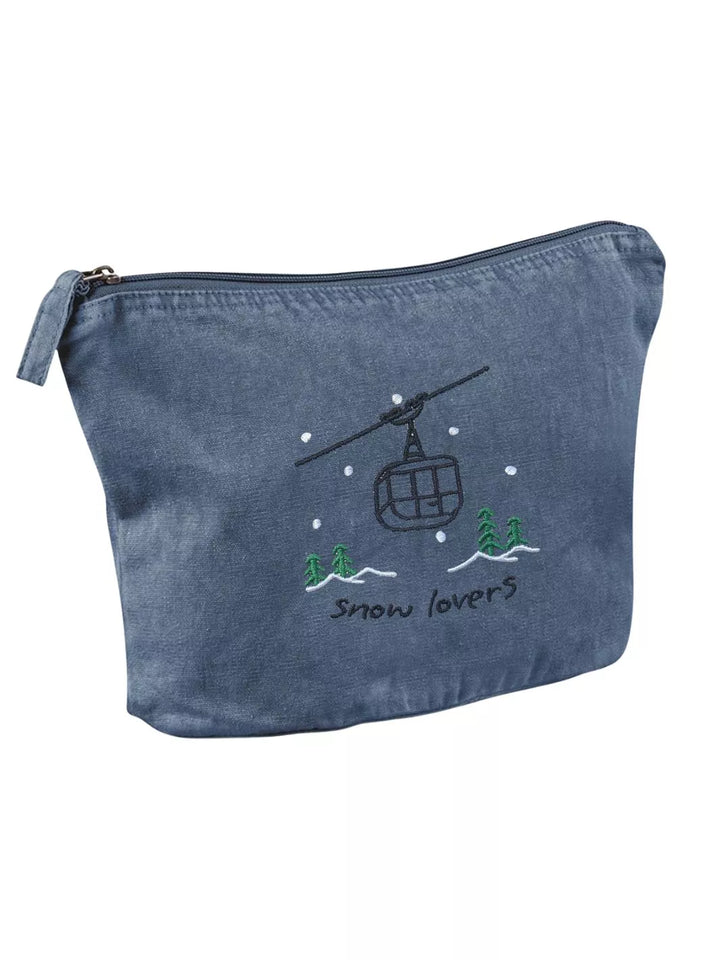 washed denim faded cotton travel pouch with embroidered cable car, pine trees, snow and Snow Lovers lettering