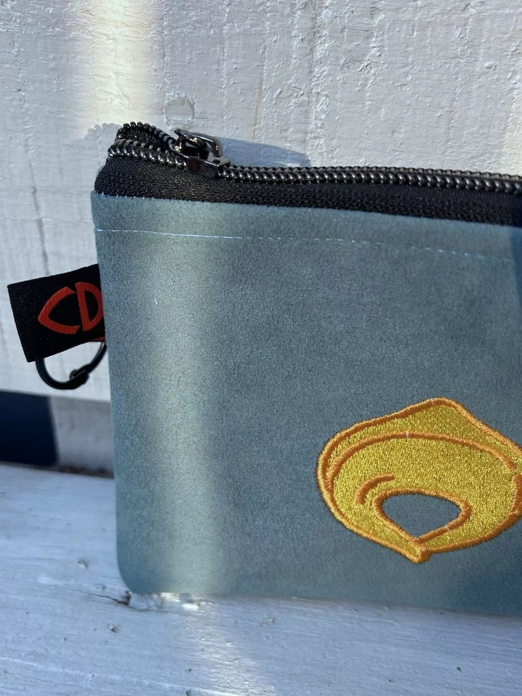 tortellino embroidered alcantara pouch