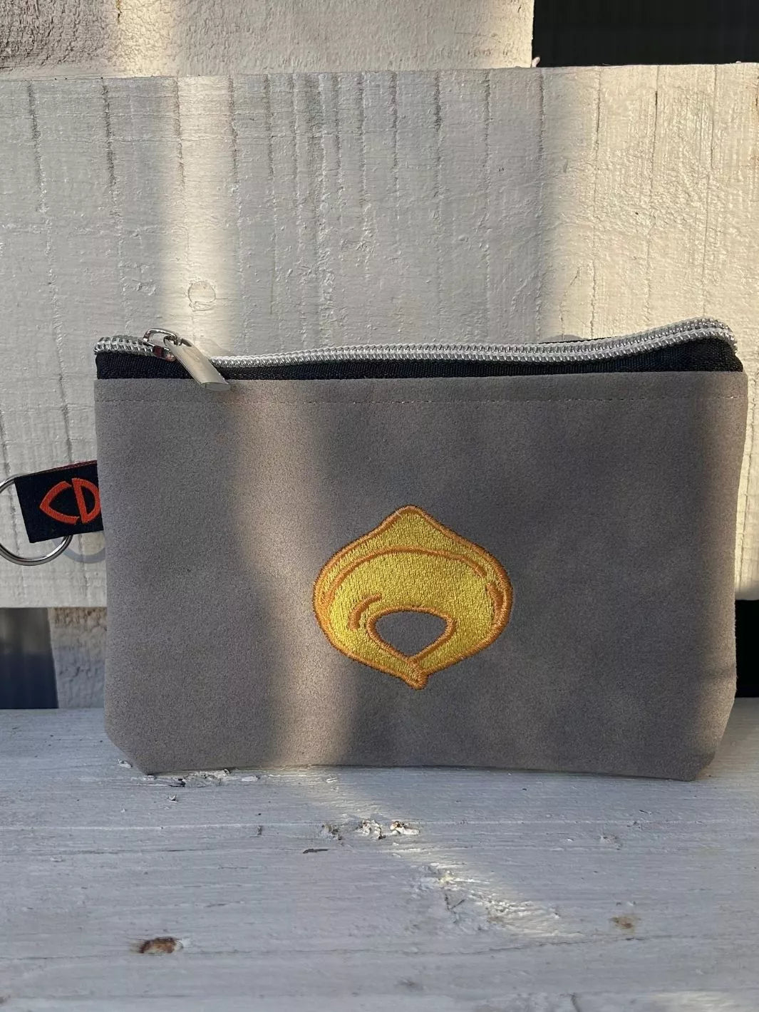 tortellino embroidered alcantara pouch