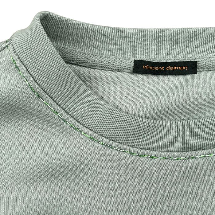 Eco-sustainable almond green sweatshirt with embroidery along the seams of the collar and right wrist