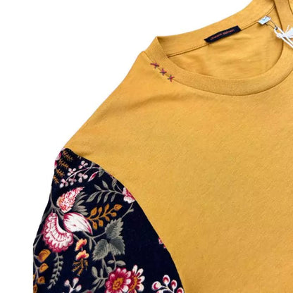 Turmeric colored boho t-shirt in organic cotton with sewn sleeves with floral motif and embroidery on the collar