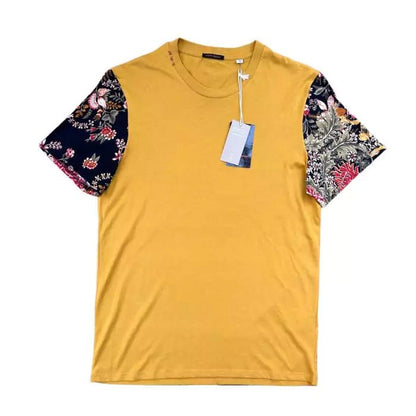Turmeric colored boho t-shirt in organic cotton with sewn sleeves with floral motif and embroidery on the collar
