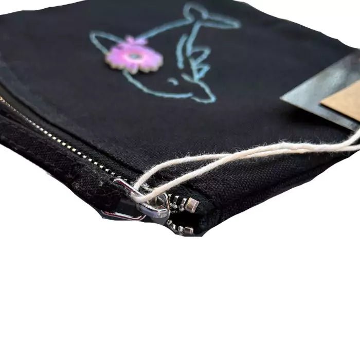 Black organic cotton clutch bag embroidered with a dolphin and flowers on the back