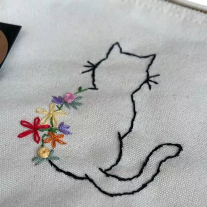 white organic cotton pochette with flowers and cat embroidered