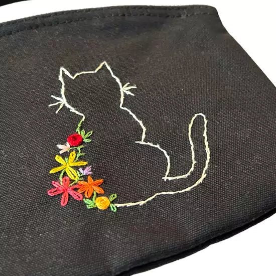 black organic cotton pochette with flowers and cat embroidered