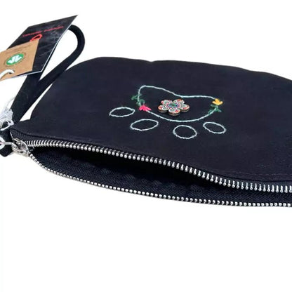 Black clutch bag in organic cotton with an embroidered dog paw adorned with flowers