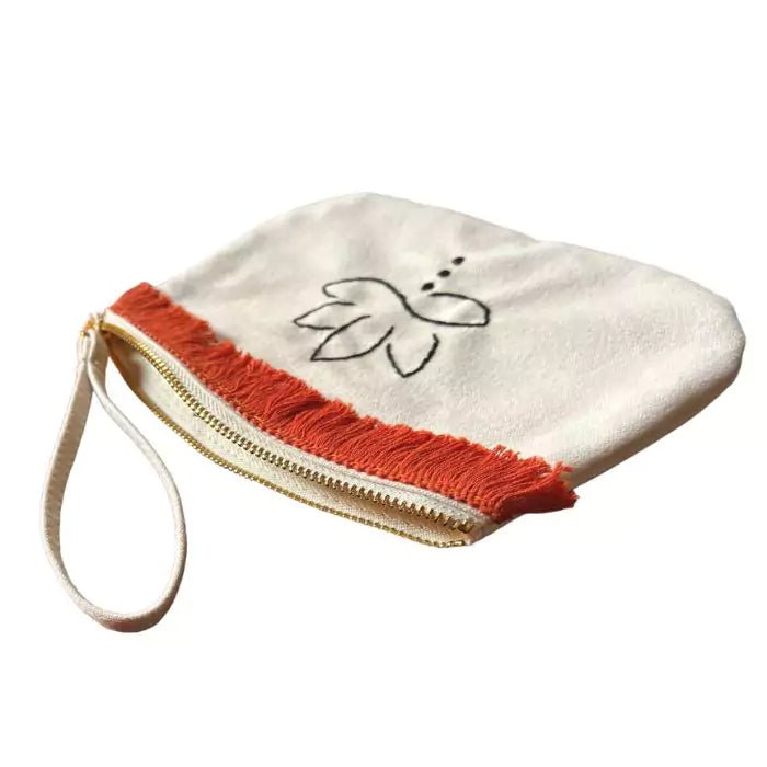 organic cotton clutch bag with a hand-embroidered lotus flower and an orange fringe sewn on top