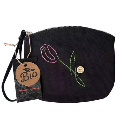 black organic cotton clutch bag embroidered with a tulip adorned with a button bearing the words "handmade with love"
