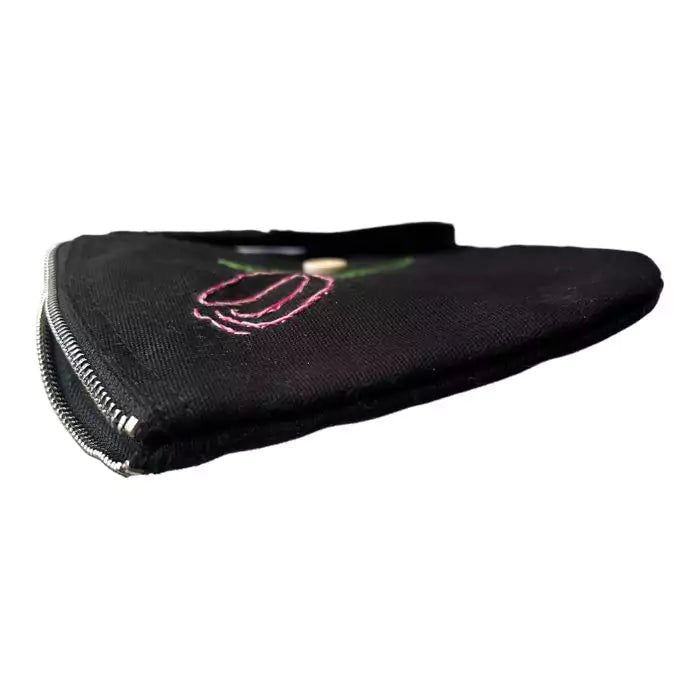 black organic cotton clutch bag embroidered with a tulip adorned with a button bearing the words "handmade with love"