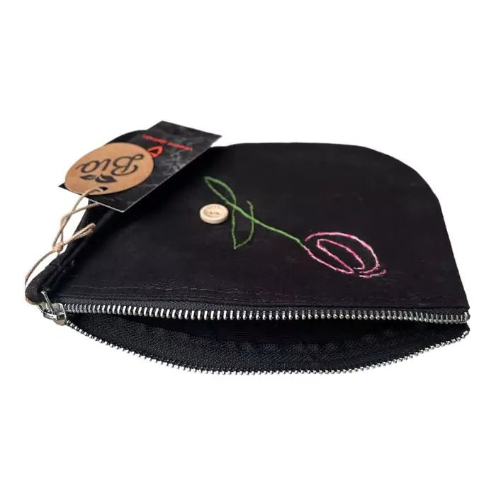 black organic cotton clutch bag embroidered with a tulip adorned with a button bearing the words "handmade with love"