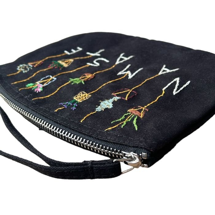 black hand-embroidered namaste clutch bag made of 100% organic cotton