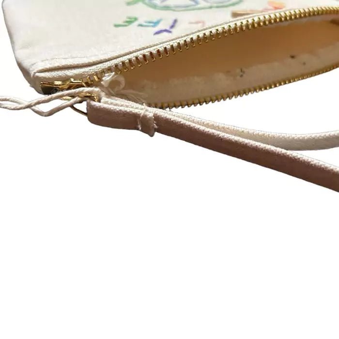 white clutch bag in organic cotton with a camper and the words "van life" embroidered on it