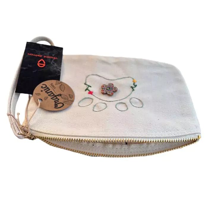 White organic cotton clutch bag embroidered with a dog paw adorned with flowers and a painted button