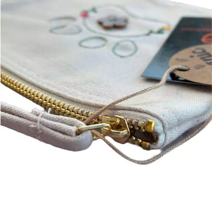 White organic cotton clutch bag embroidered with a dog paw adorned with flowers and a painted button