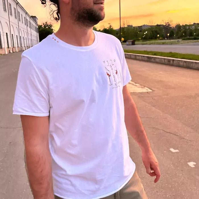White organic cotton t-shirt with three "x" embroidered on the collar and golden hour print with glasses on the heart side
