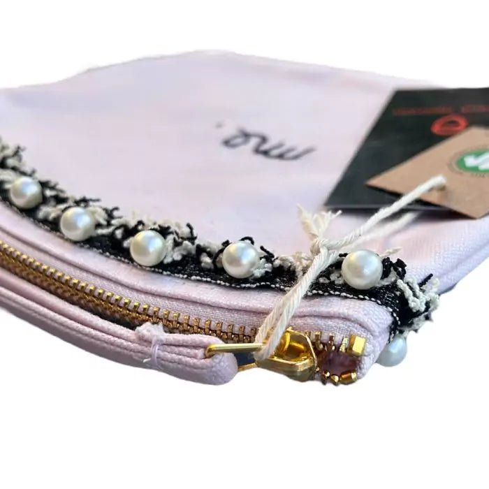 pastel pink organic cotton clutch bag with stitched trimmings and embroidered word