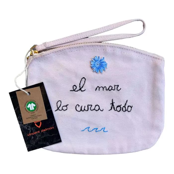 pink organic cotton clutch bag embroidered with the words "el mar lo cura todo"