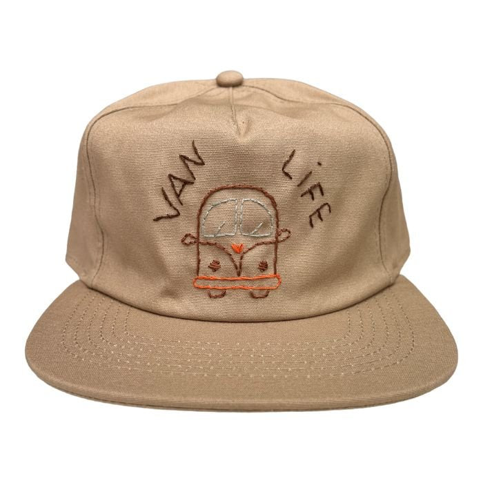 Sand-colored snapback with a camper and the words "van life" embroidered on it