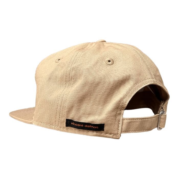 Sand-colored snapback with a camper and the words "van life" embroidered on it