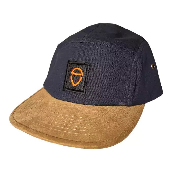 navy blue snapback and with a sand-colored visor with embroidered logo patch