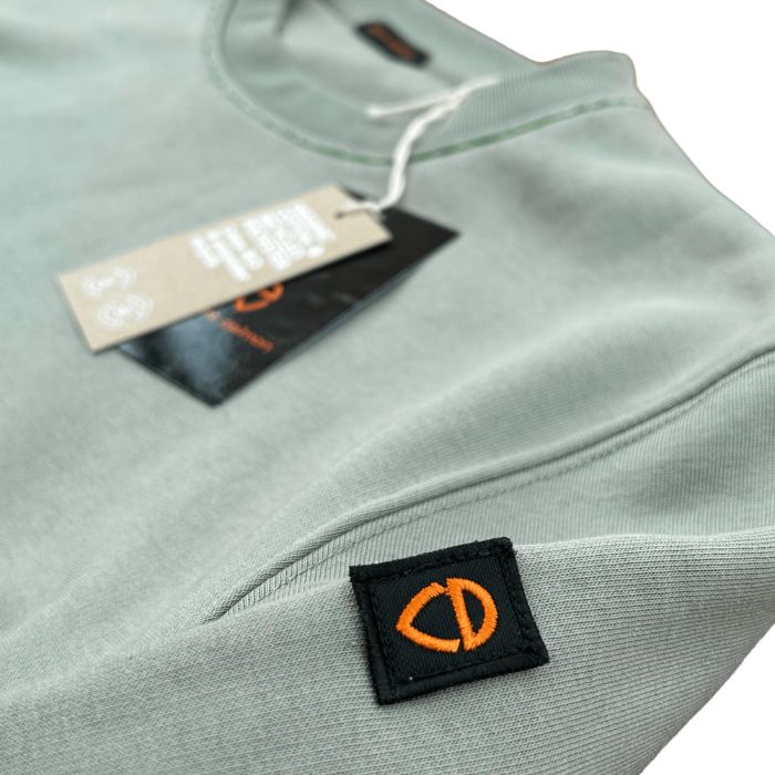 Eco-sustainable almond green sweatshirt with embroidery along the seams of the collar and right wrist