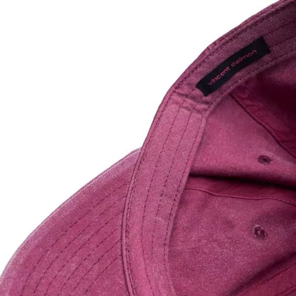 Vintage red baseball cap with irregular washouts on the surface